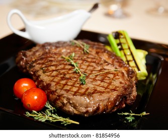 Rib Eye Steak Served On Black Plate