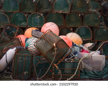 Ribadeo, Galicia, Spain. Close up view of row of octopus traps and orange and white buoys in the harbour.