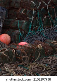 Ribadeo, Galicia, Spain. Close up view of row of octopus traps, orange buoy and ropes in the harbour.