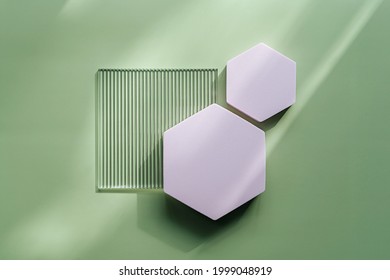 Ribbed acrylic plate and hexagon  on green background with  shadow. Stylish background for presentation. 
