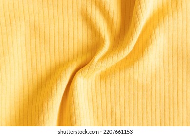 Ribbed Cotton Fabric Texture Yellow Color  . Close Up Rib Cotton Cloth And Textiles Pattern. Natural Organic Fabrics Texture Background.