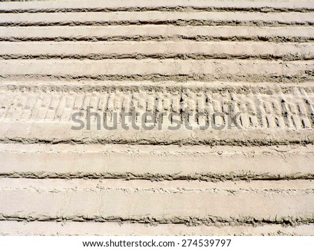 Ribbed wheel tracks on dry sand. Perfect sand texture for background.