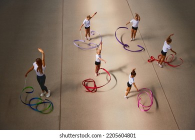 Ribbon Exercises. Aerial View. Female Sports Coach Training Gymnastics Athletes At Sports Gym, Indoors. Concept Of Achievements, Studying, Goals. Coaching, Training, Child Psychology