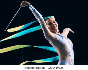 Ribbon gymnastics, woman and portrait on black background of dancer, performance and competition. Female athlete, rhythmic movement and smile for action, creative talent and elegant sports concert - Powered by Shutterstock