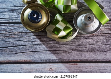 Ribbon Ketupat And Oil Lamp On The Wood Texture Background