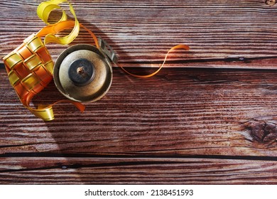 Ribbon Ketupat And Oil Lamp On The Wood Texture Background