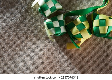 Ribbon Ketupat On The Jute Texture Background