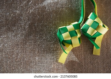 Ribbon Ketupat On The Jute Texture Background