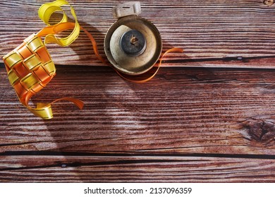 Ribbon Ketupat On The Wood Texture Background