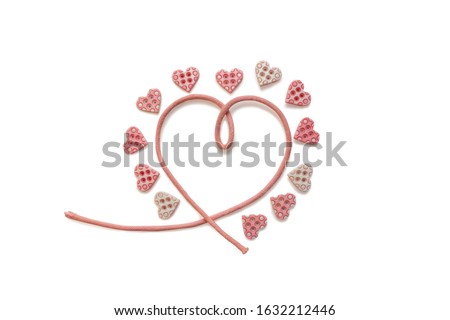 Ribbon rose heart and Tiny heart shape buttons around it. Isolated on white background. Romantic symbol of Love. Happy Valentine's Day. Top view, close up, flat lay.