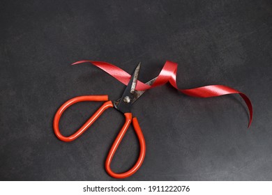 Ribbon scissors on a black background, suitable for presentations (focus selection).