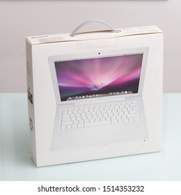 Ribeirao Preto, Sao Paulo / Brazil - August, 26, 2019: Old Macbook White Box, Year 2009 On A Glass Table