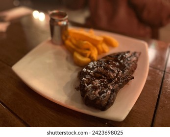 Ribeye Steak and Steak Burgers with Sweet Potato Fries in cloudy presentation - Powered by Shutterstock