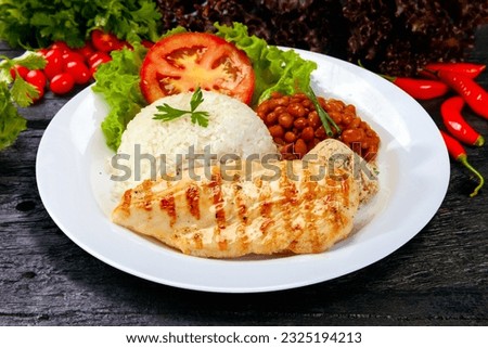 Rice beans grilled chicken steak salad and farofa