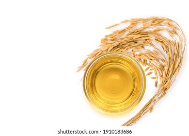 Rice bran oil extract with paddy unmilled rice on white background. Top view. Flat lay.