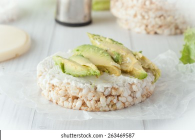 Rice Cake With Cream Cheese And Avocado On White Background