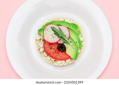 Rice Cake Sandwich with Avocado, Tomato, Cottage Cheese, Olives and Radish on White Plate. Easy Breakfast. Diet Food. Quick and Healthy Sandwiches. Crispbread with Tasty Filling. Healthy Dietary Snack