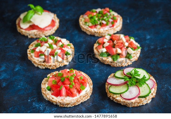 rice crisp cracker\
with chopped vegetables tomato cucumber radish parsley soft cheese\
.healthy snack