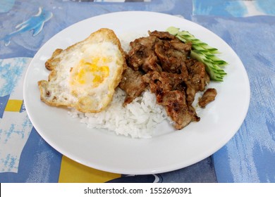 Rice With Fried Pork With Garlic And Fried Egg On Top