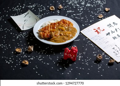 Rice With Fried Pork And Japanese Curry Or Katsu Curry In A White Plate. The Traditional Dish Of Japanese Cuisine. View From Above.