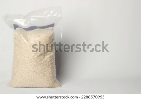 Rice inside plastic isolated on a white background with copy space. zakat concept