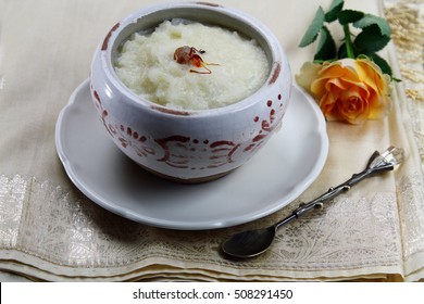 Rice Kheer Or Rice Pudding In A Bowl On A Silk Cloth With A Rose