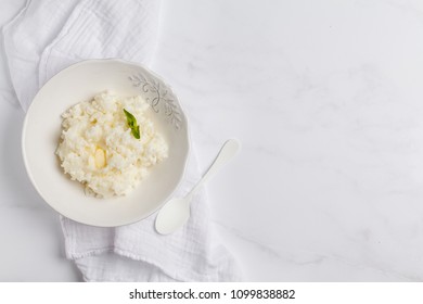 Rice Milk Porridge With Butter For Breakfast. White Background, Top View, Copy Space.