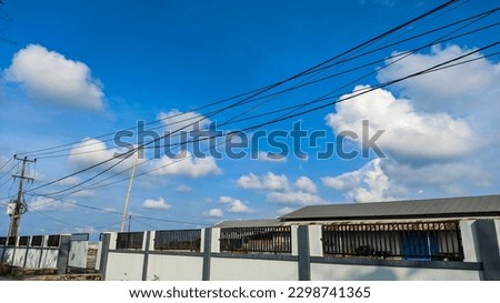a rice mill against a blue sky full of clouds during the day
