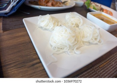 Rice noodle in the palette white triangle on the dining table. - Powered by Shutterstock