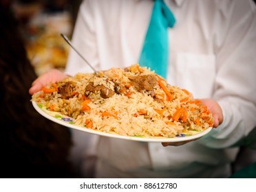 Rice pilaf with meat - plov on the plate