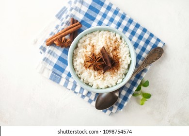 Rice Porridge With Cinnamon In A Bowl On A Light Concrete Background. Top View