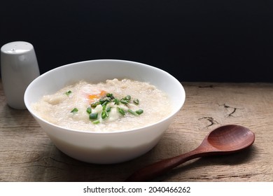 Rice Porridge With Pork And Egg Or Congee Is Similar To Boil Rice But It Has Softer Texture Is On The Wooden Table For Breakfast In The Moring
