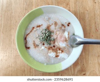 rice porridge with pork and egg in the morning food top view - Shutterstock ID 2359628691