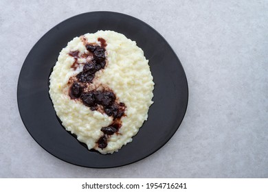 Rice Pudding With Sour Cherry Jam, On A Ceramic Black Plate