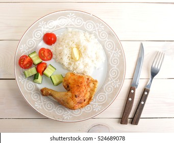 Rice With Roasted Chicken Leg And Cucumber With Tomatoes On Plate On Wooden Background - Top View