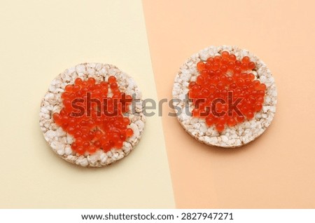 Rice round bread with red caviar on beige background