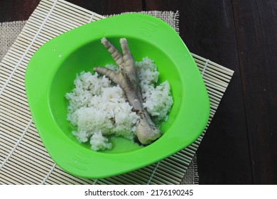 Rice With A Side Dish Of Soft And Tender Chicken Leg Soup Served On A Plastic Plate And An Aesthetic Base