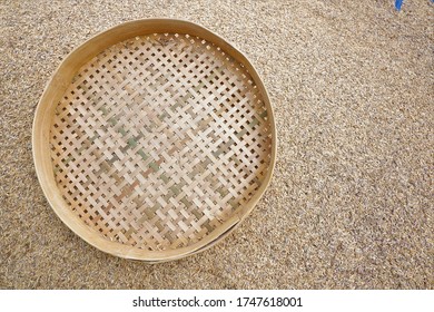 Rice Sieve On A Stretch Of Dried Rice Seeds