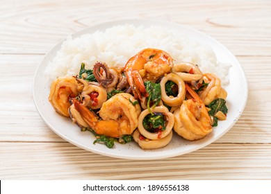 rice and stir-fried seafood (shrimps and squid) with Thai basil - Asian food style
