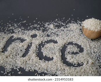 RICE text written with rice grains on grey background. - Shutterstock ID 2314953183