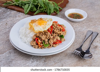 rice topped with stir-fried mince pork and basil with fried egg , Thai famous Street food