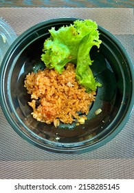 Rice And Vegetable Food Waste On Black Plastic Bowl