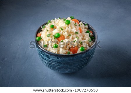 Rice with vegetables on a dark blue background, easy recipe