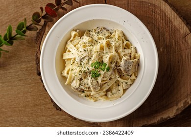 Rich Alfredo Fettuccine: Creamy pasta perfection with al dente ribbons in a velvety sauce. Classic Italian comfort in every bite. - Powered by Shutterstock