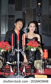 
Rich Asian Couple In Black Dress Posing At Candle Light Dinner Decoration Table. Jakarta March 16, 2016