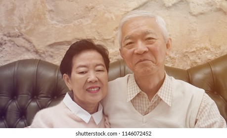 Rich Asian Senior Parents Sit In Luxury Beautiful House