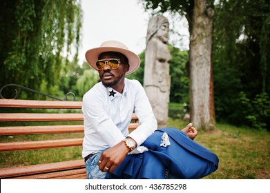 Rich Black Man Sitting On Bench At Golden Sunglasses And Hat 