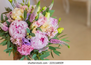 Rich bunch of pink peonies and lilac eustoma roses flowers, green leaf . Fresh spring bouquet. Holodays, gift.Arrangement of Beautiful blossoming flowers.wedding bouquet.copy space