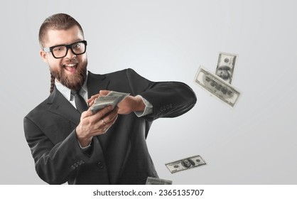 Rich businessman in suit scatters money - Shutterstock ID 2365135707