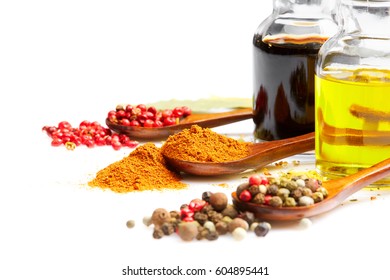 Rich colorful cuisine & healthy lifestyle concept: Fragrant spices olive oil balsamic. Olive oil, balsamic, red white & black peppers, paprika, Italian herbs. Closeup. Isolated on white  - Shutterstock ID 604895441